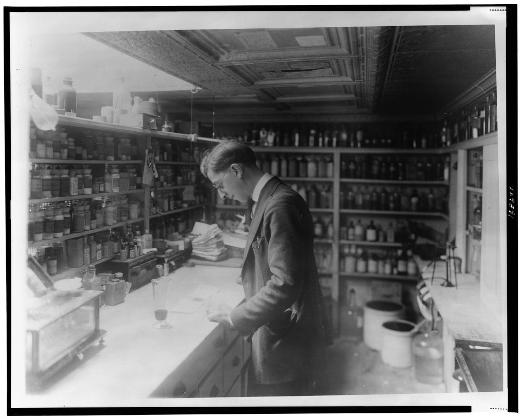 Historic pharmacy interior with shelves of medicine bottles