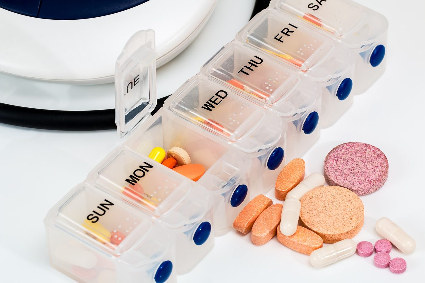 Blister pack and tablets arranged on a light surface